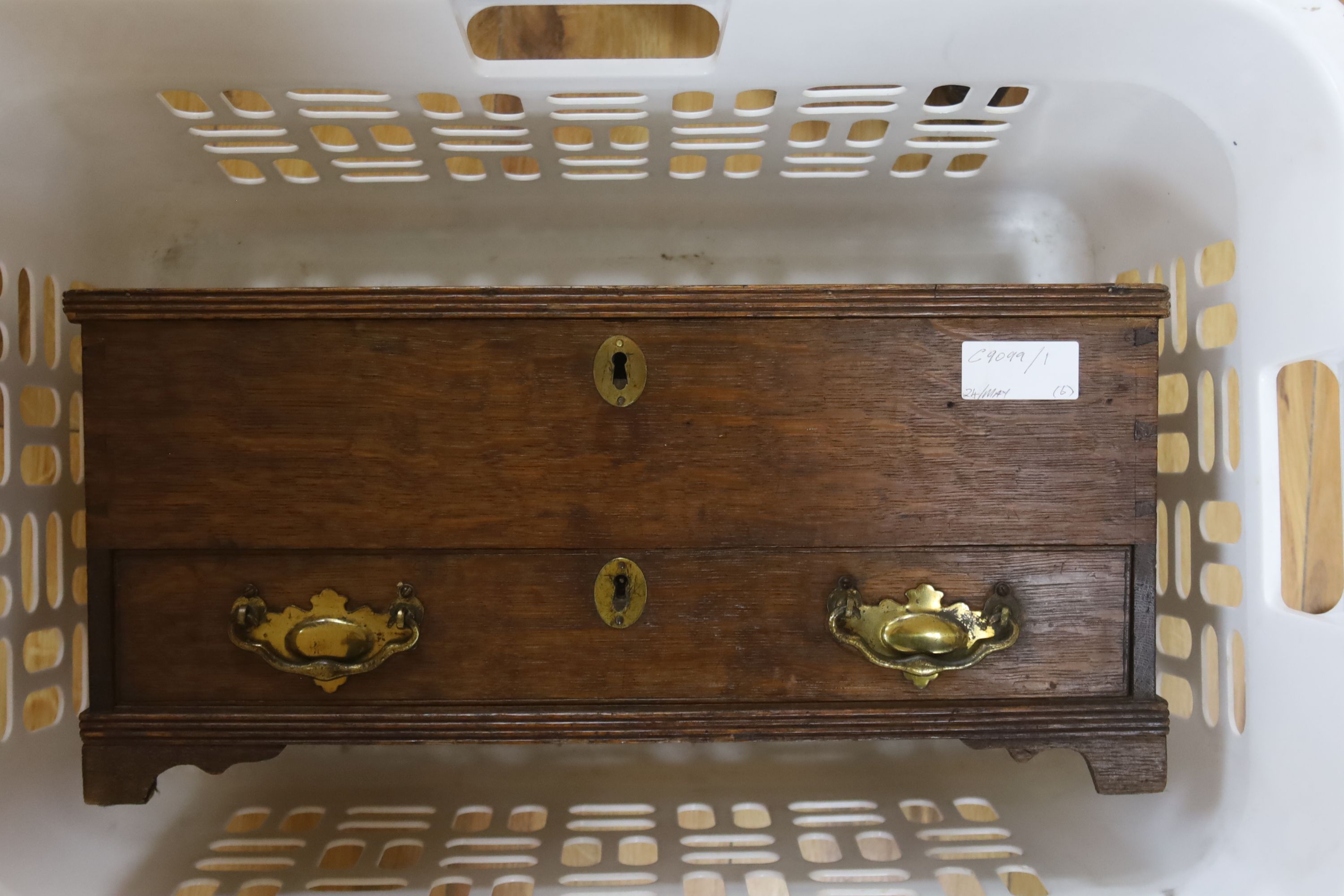 An 18th/19th century oak miniature trunk and miniature corner cupboard, one other miniature oak coffer, pair of candlesticks and leathe